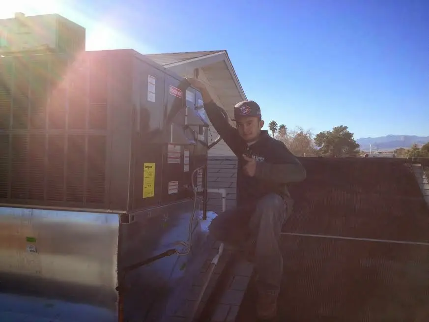 HVAC technician performing HVAC Inspection on a rooftop unit in Vinings